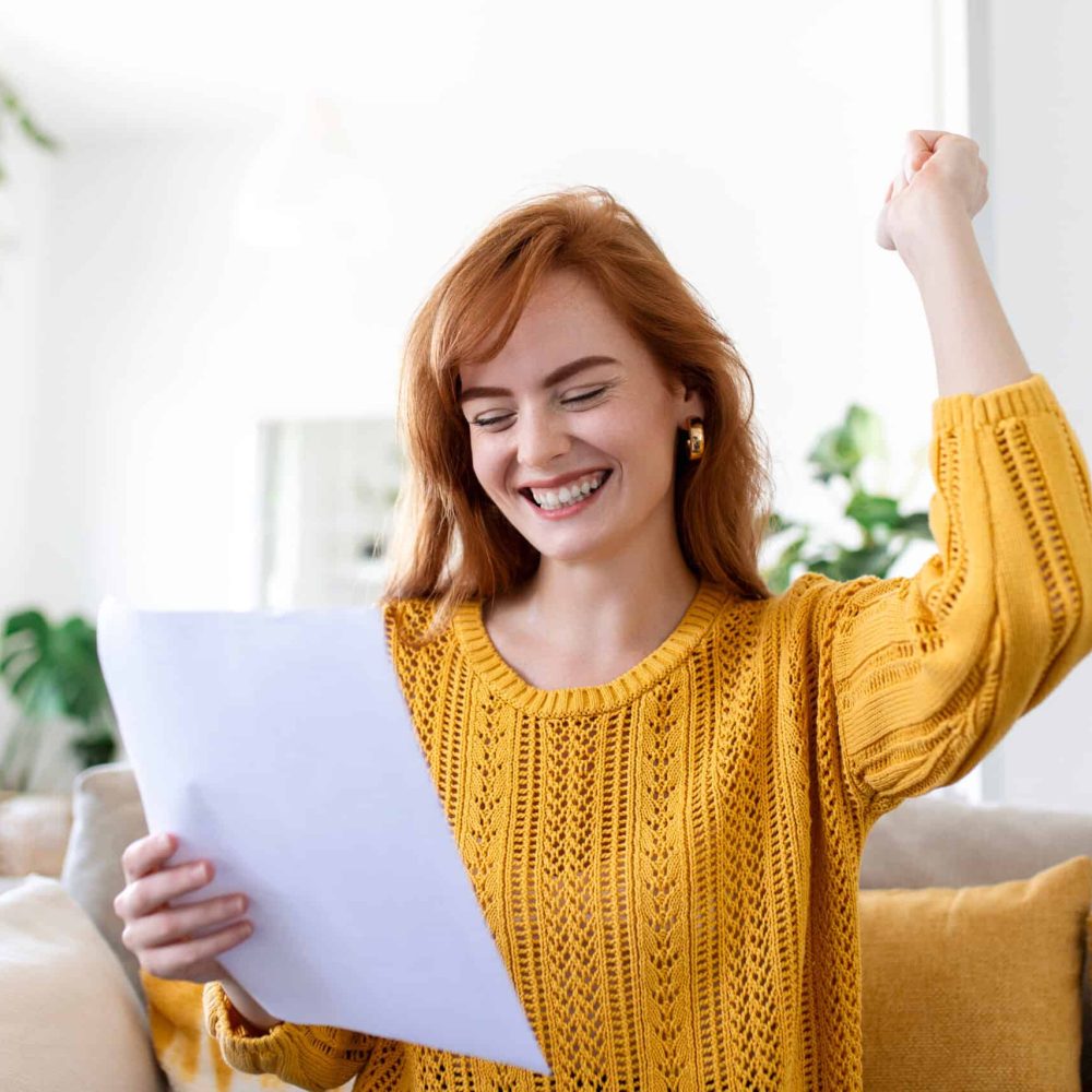 Excited young woman hold paper letter feel euphoric receiving job promotion or tax refund from bank, happy woman reading paperwork document smiling of good pleasant news, getting student scholarship